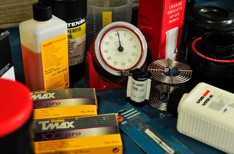Black and white image showing a wooden filing tray filled with numbered and labelled index cards, with some cards marked 'ILFORD' and 'NON-ULTRA FOG'. The tray is situated on a surface inside a proper